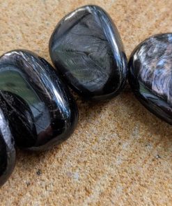 Black crystal stone Hypersthene meaning, metaphysical and healing properties, Grounds spiritual energy, forms protective shield around the body