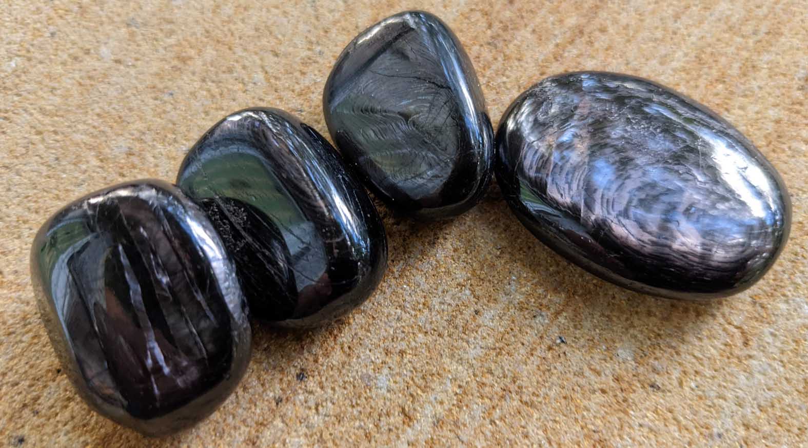 Black crystal stone Hypersthene meaning, metaphysical and healing properties, Grounds spiritual energy, forms protective shield around the body
