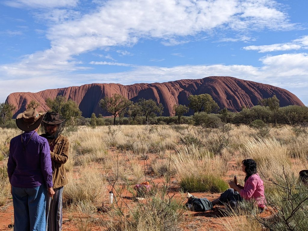 View of Uluru Tuesday 11am with Isheena Ocha and Jessie resting in foreground