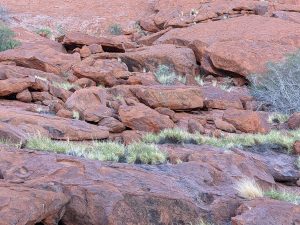 Boulders and rocks at base of Uluru and part of the ancient monolith