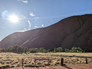 View of Uluru during sunrise and start of the base walk